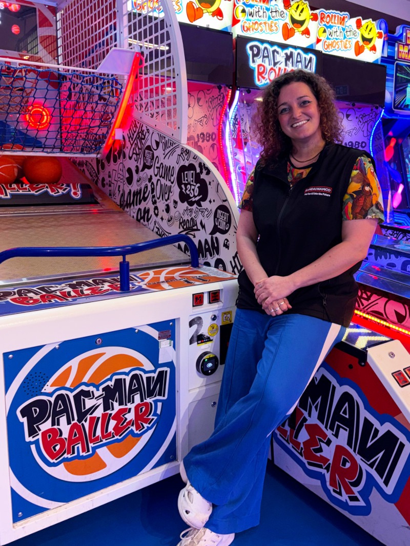 Steph Jones of Bandai Namco Amusement Europe posts with a Pac-Man Baller machine