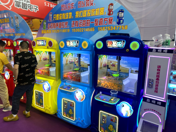 Crane machines featuring live goldfish as prizes at AAA 2024.