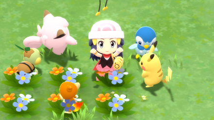 The main character from sitting alongside Pikachu and friends in a flower patch in Pokémon Brilliant Diamond and Pokémon Shining Pearl