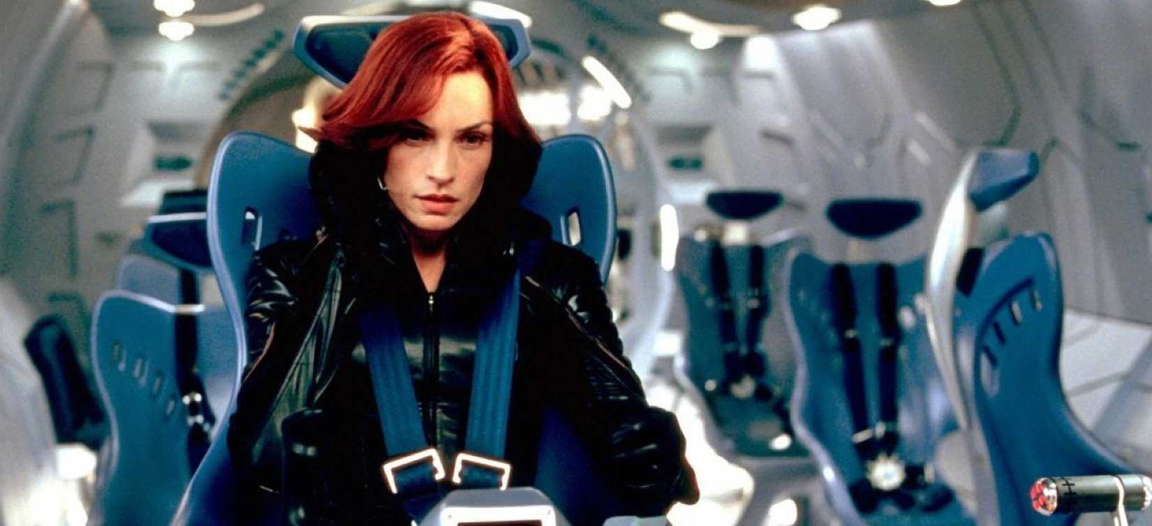 Jean Grey (Famke Janssen) sits in the X-Men’s plane, surrounded by gleaming blue seats and silver walls, in X2: X-Men United