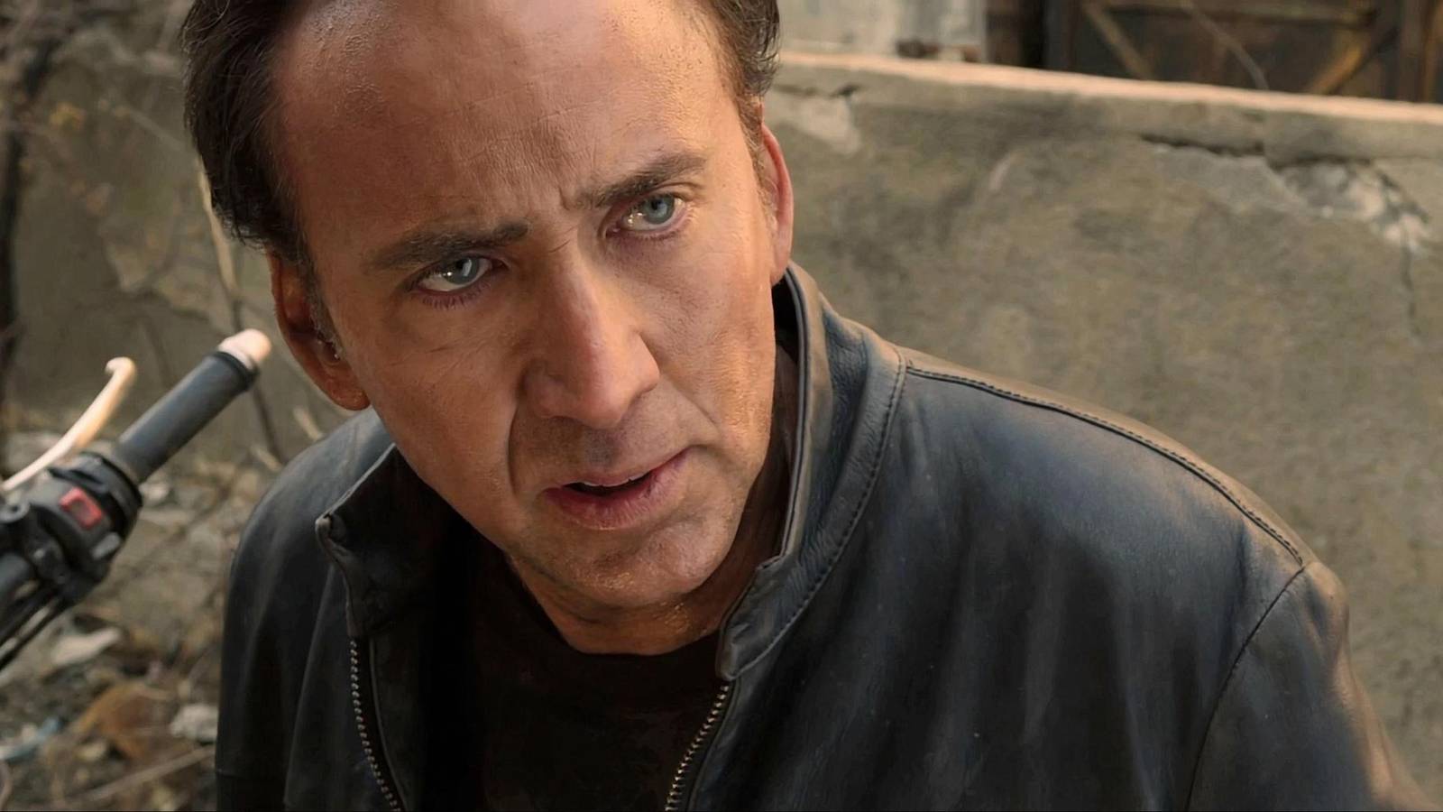a close up of nicolas cage sitting on a motorcycle, looking stunned in ghost rider spirit of vengeance