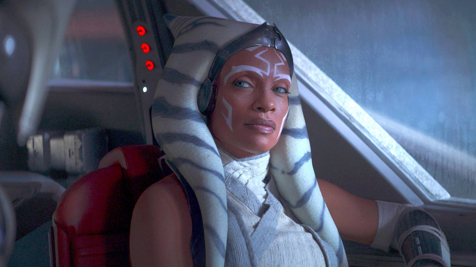 Ahsoka (Rosario Dawson) sits and looks at something with a side eye