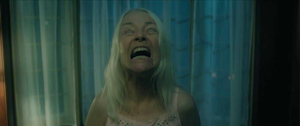 A woman with white hair screaming in Bury the Devil