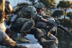 Soldiers vaulting over a ledge with guns drawn.