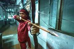 Yayan Ruhian aims a bow and arrow in The Furious