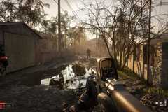 A screenshot from hardcore Steam shooter, Wardogs. The protagonist is holding a rifle while patrolling an area at dusk.