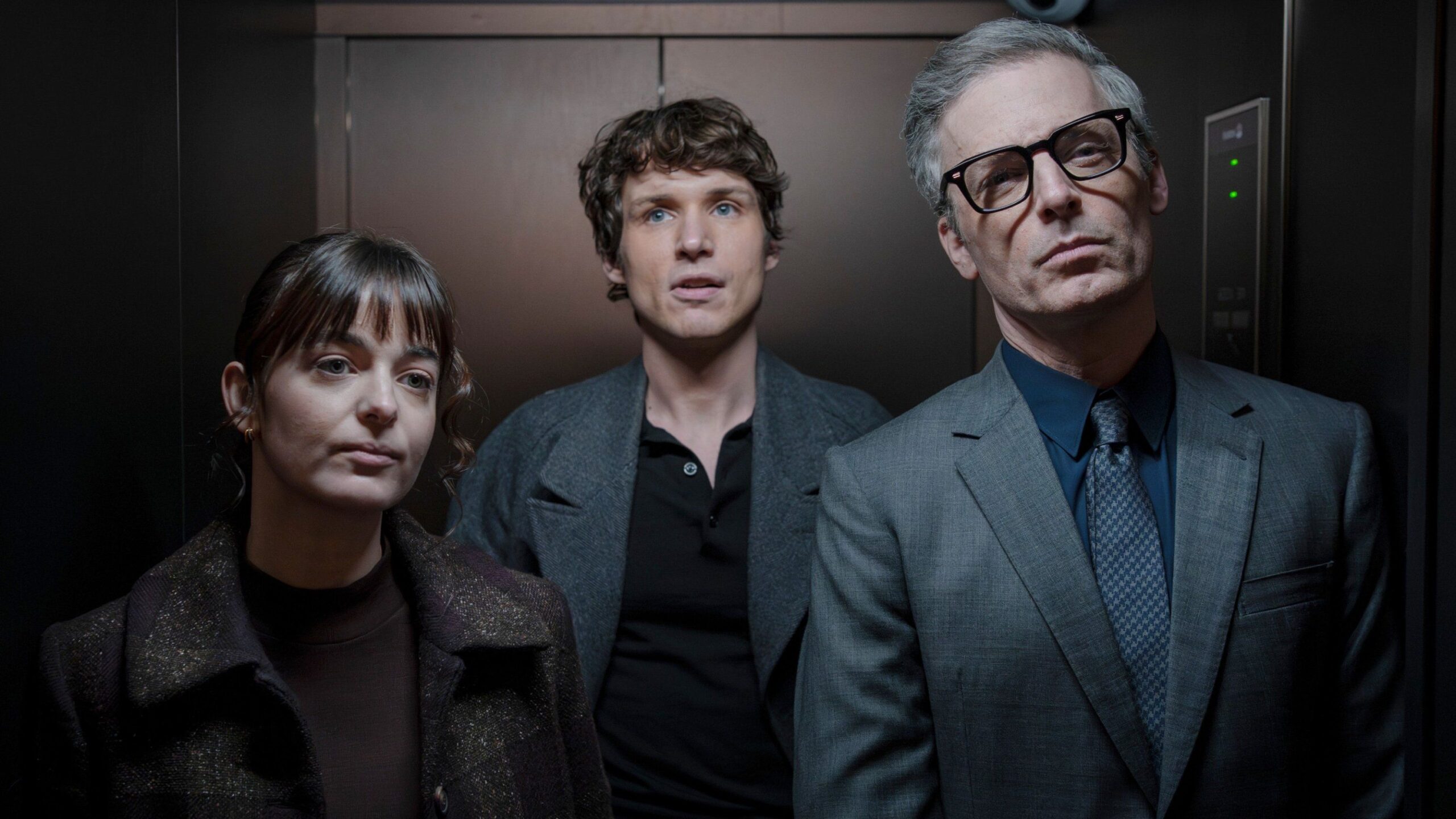 Doris (Celine Buckens), Guy Anatole (Nicholas Denton) and  Raglan Jones (Justin Kirk) stand in an elevator in Talamasca the Secret Order