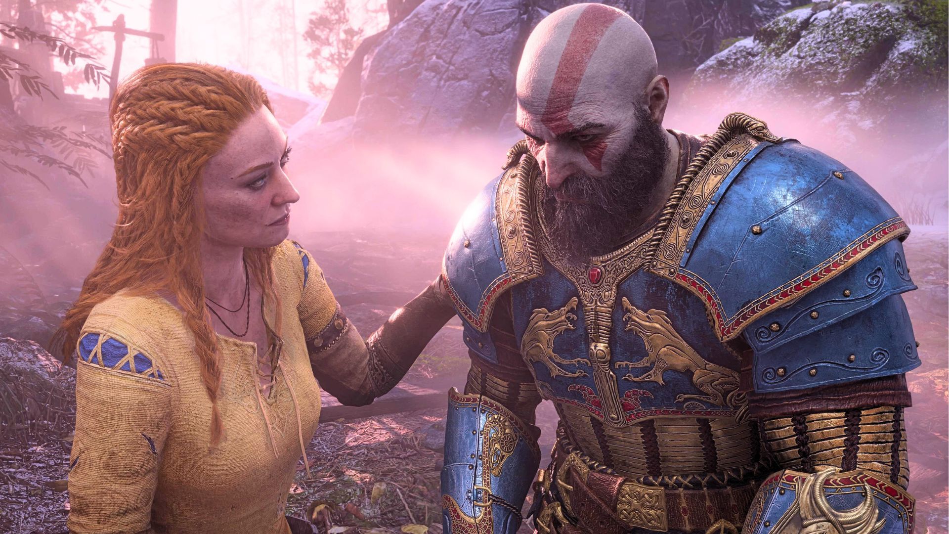 An image from God of War (2018) showing Faye, a red-haired woman with a yellow and blue tunic on, putting a hand on her husband, Kratos' plated shoulder.