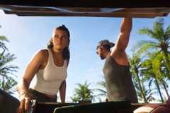 Jason and Lucia pulls guns from the trunk of a car in a screenshot from Grand Theft Auto 6