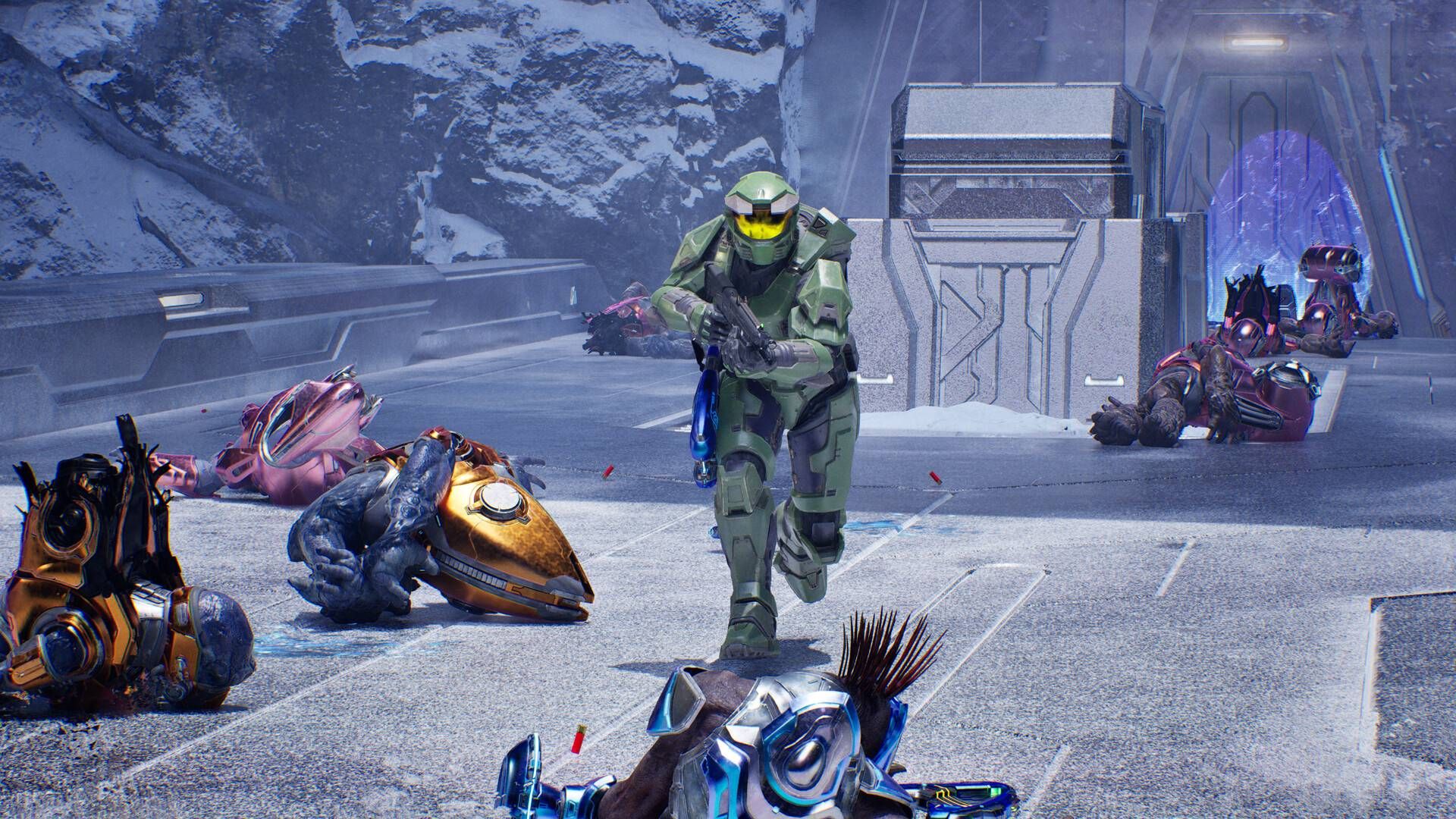 Master Chief running past dead Covenant in Halo: Campaign Evolved.