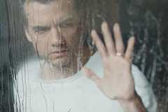 The Last House- Wagner Moura puts his hand on a rainy window