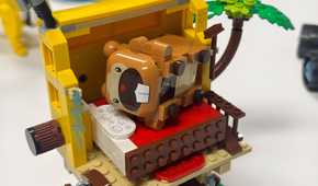 A Lego Bidoof lays in a toy bed.