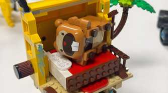 A Lego Bidoof lays in a toy bed.