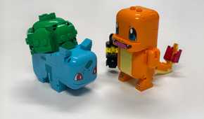 A Lego Bulbasaur and Charmander stand on a table.