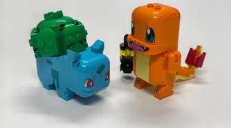 A Lego Bulbasaur and Charmander stand on a table.