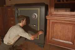 Enzo opening a safe in Mafia: The Old Country.