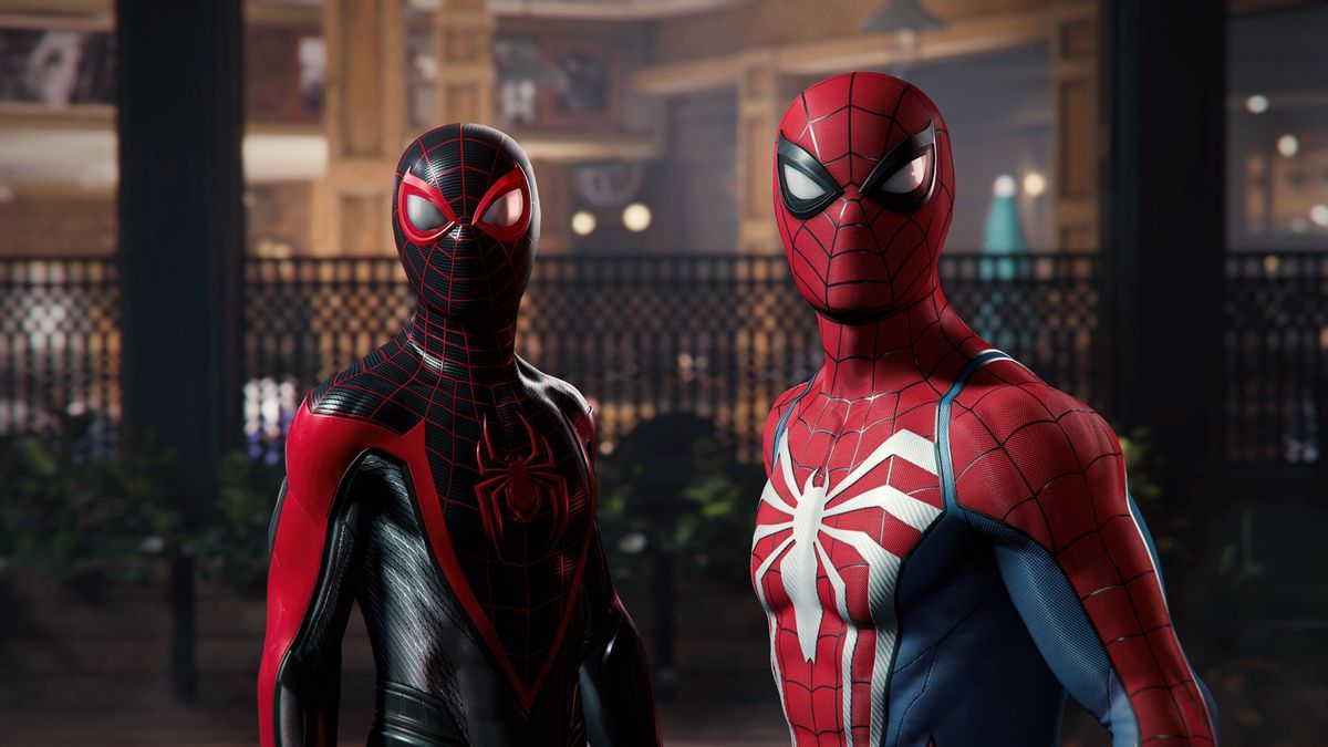 Miles Morales stands next to Peter Parker and looks off and to the left of the camera in Marvel’s Spider-Man 2