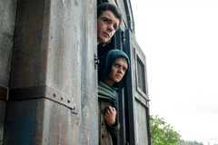 Larys Strong (Matthew Needham) and Aemond (Tom Glynn-Carney) poke their heads out of a carriage in house of the Dragon season 3 episode 2