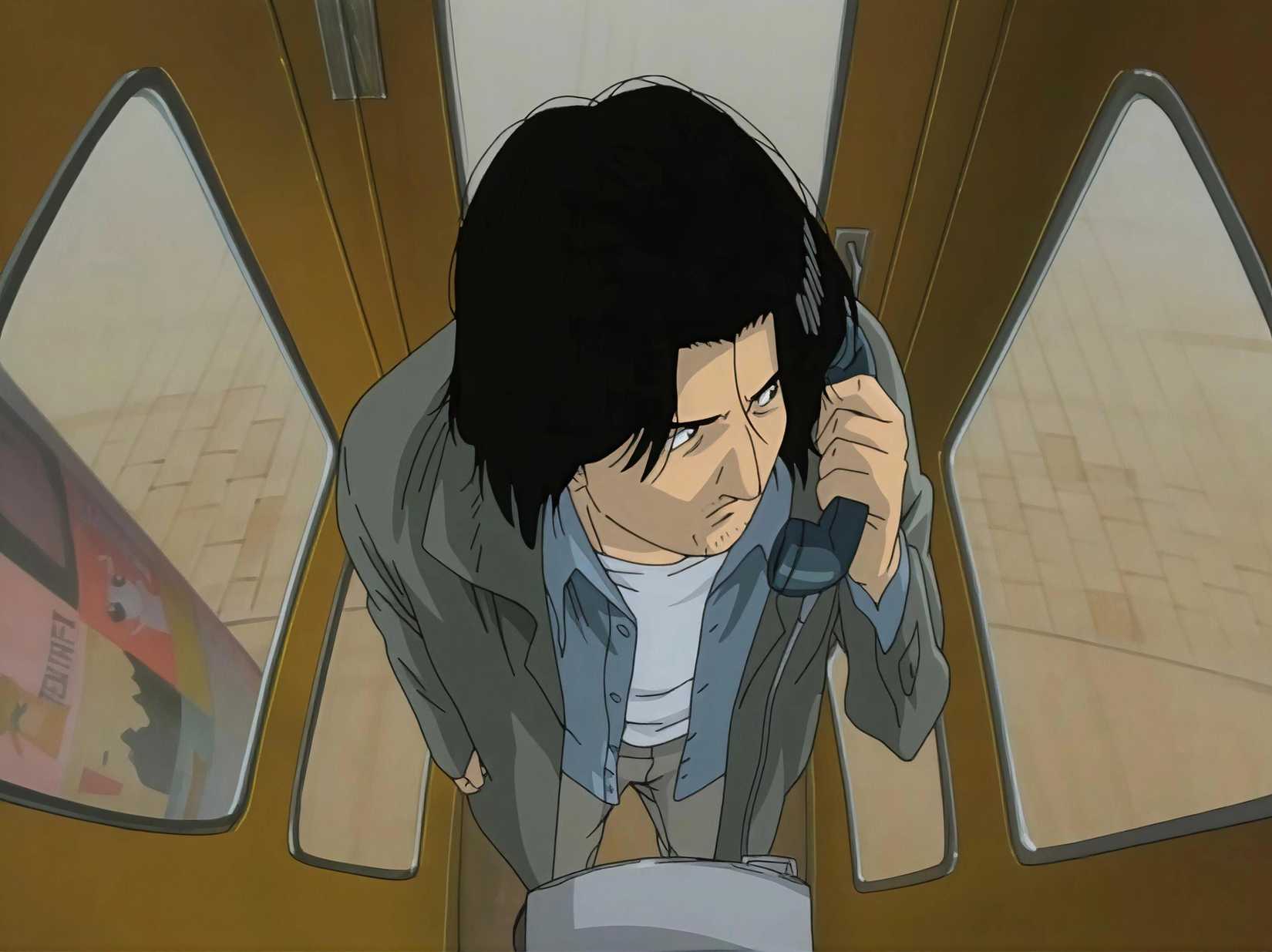 Kenzo Tenma makes a phone call inside a claustrophobic booth in Monster