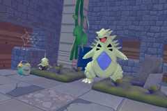 Larvitar and Tyranitar in their moss habitats in Pokopia