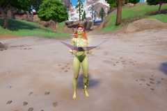 Poison Ivy, a woman with red hair and green skin, sunbathing on a beach in Fortnite.