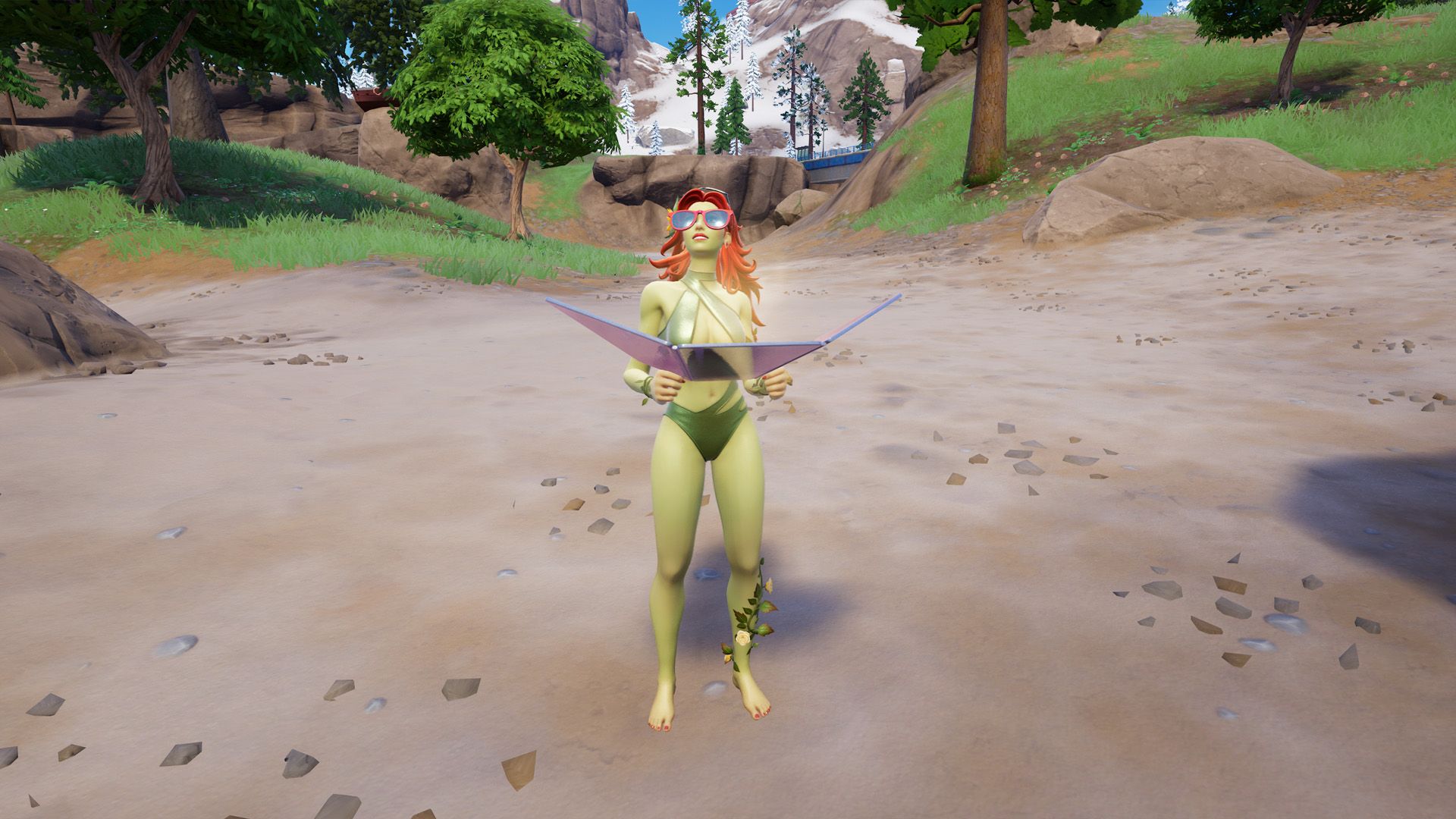 Poison Ivy, a woman with red hair and green skin, sunbathing on a beach in Fortnite.