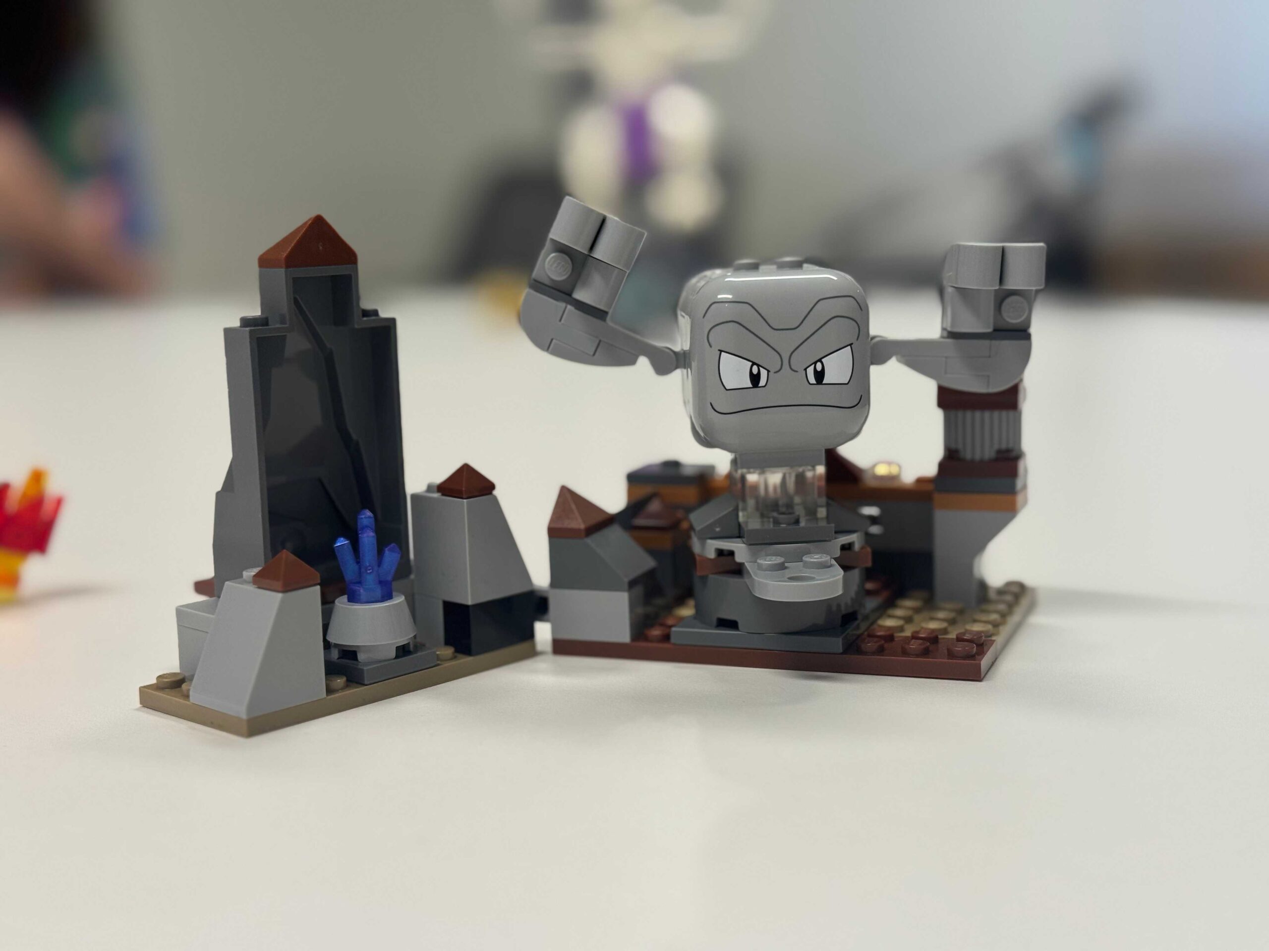 A Lego Geodude sits on a table.
