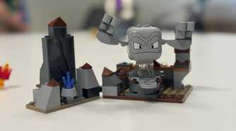 A Lego Geodude sits on a table.