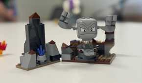 A Lego Geodude sits on a table.
