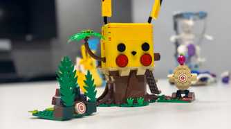 A Lego playset that looks like Pikachu sits on a table.
