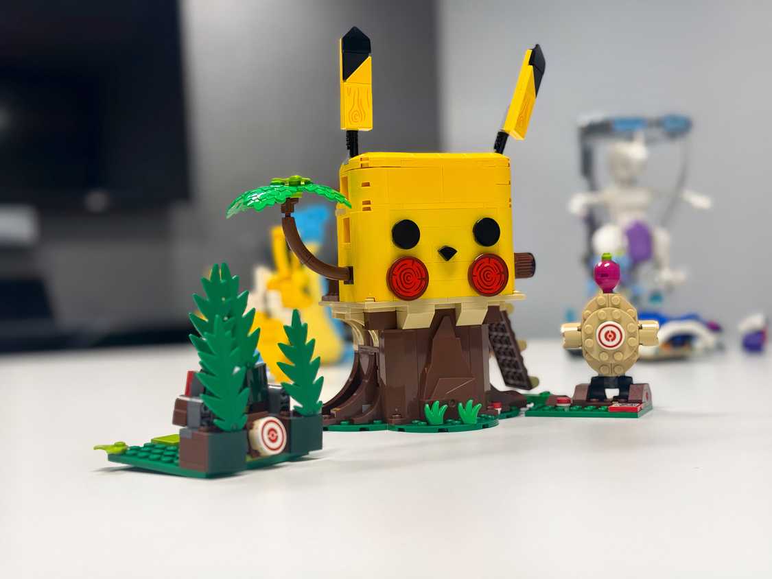 A Lego playset that looks like Pikachu sits on a table.