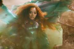 Quintessa Swindell as Cyclone uses her wind powers in a swirl of blurred CGI color in Black Adam
