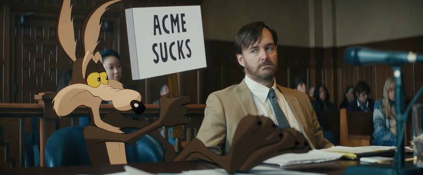 Wile E. Coyote hold a sign that reads "ACME sucks"