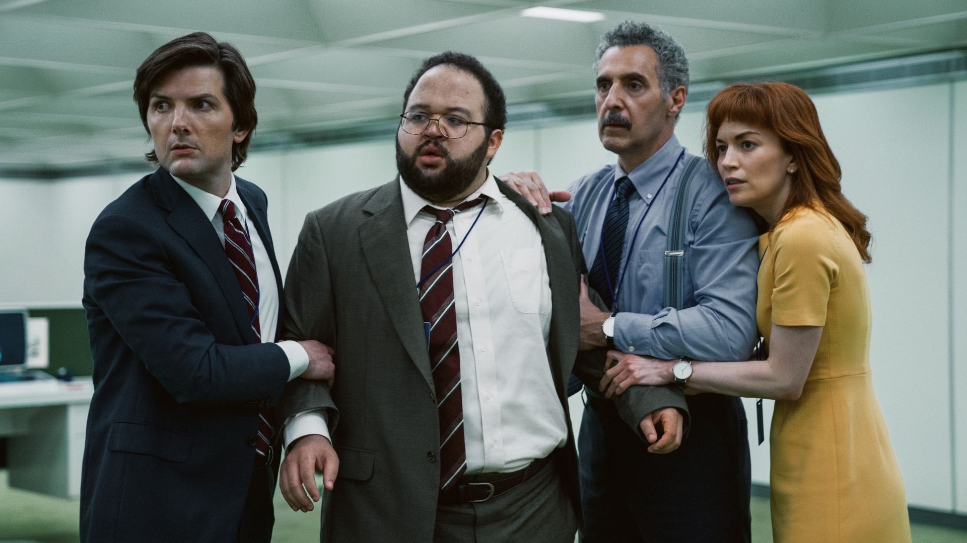 The innies of Severance huddled around each other and holding Dylan back