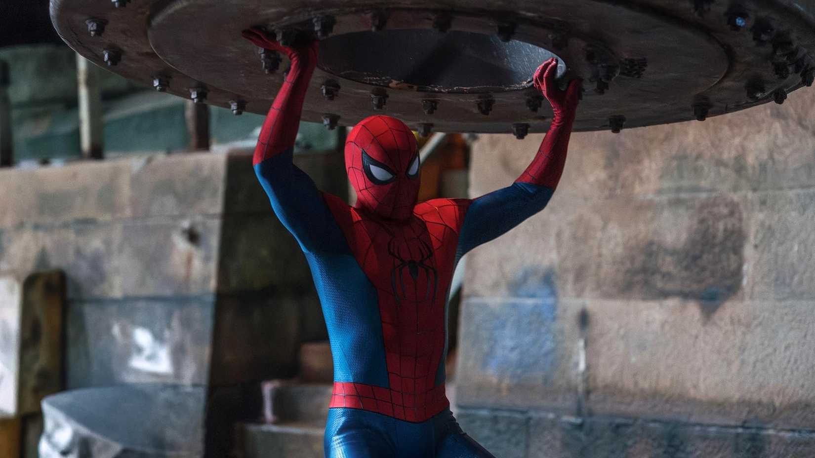 Spider-Man: Brand New Day - Spider-Man holds up a large metal object