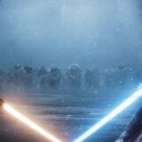Light sabers appear in a dark area.