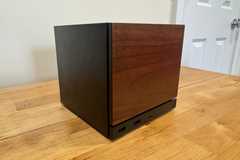 A Steam Machine with a wooden faceplate sits on a table.