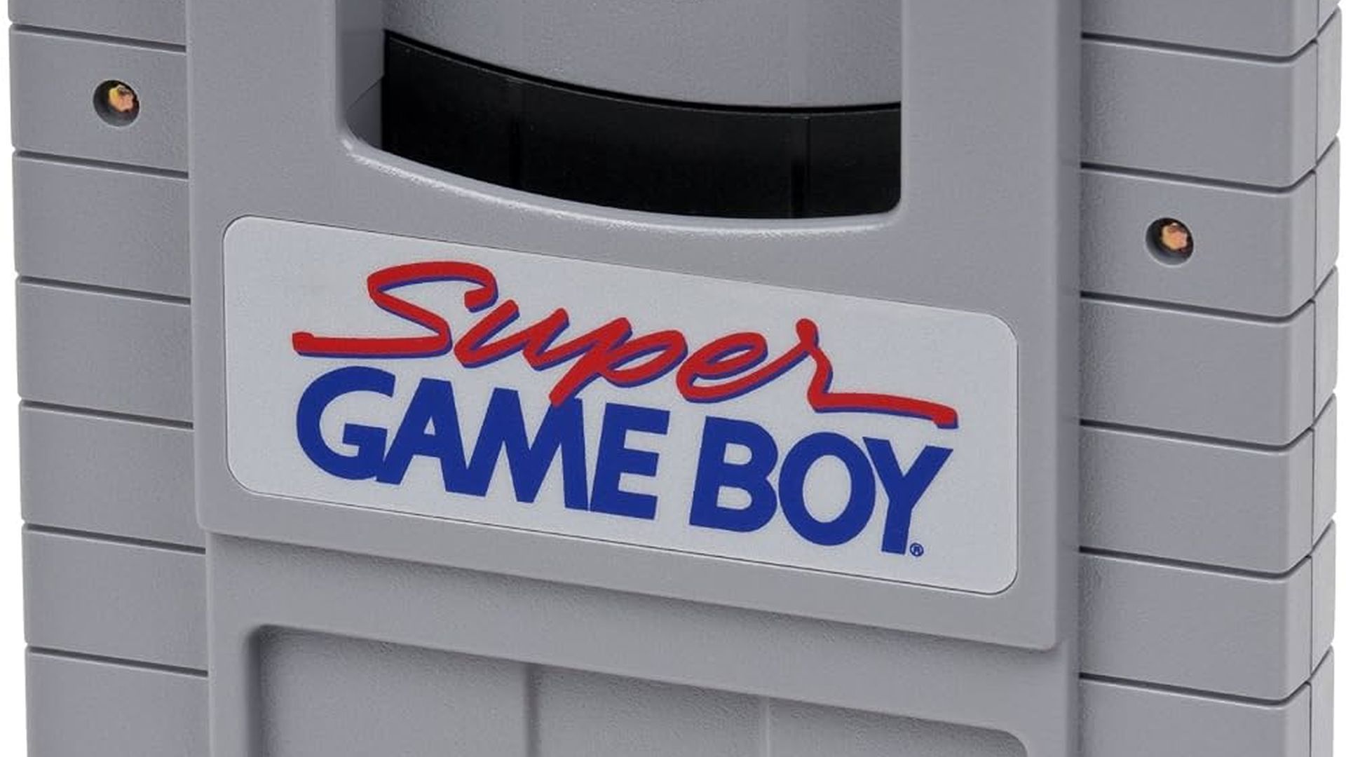 A closeup of the Super Game Boy device, showing the front-facing logo and a cartridge slot.