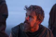 Matt Damon as Odysseus looking off screen against a blue background.