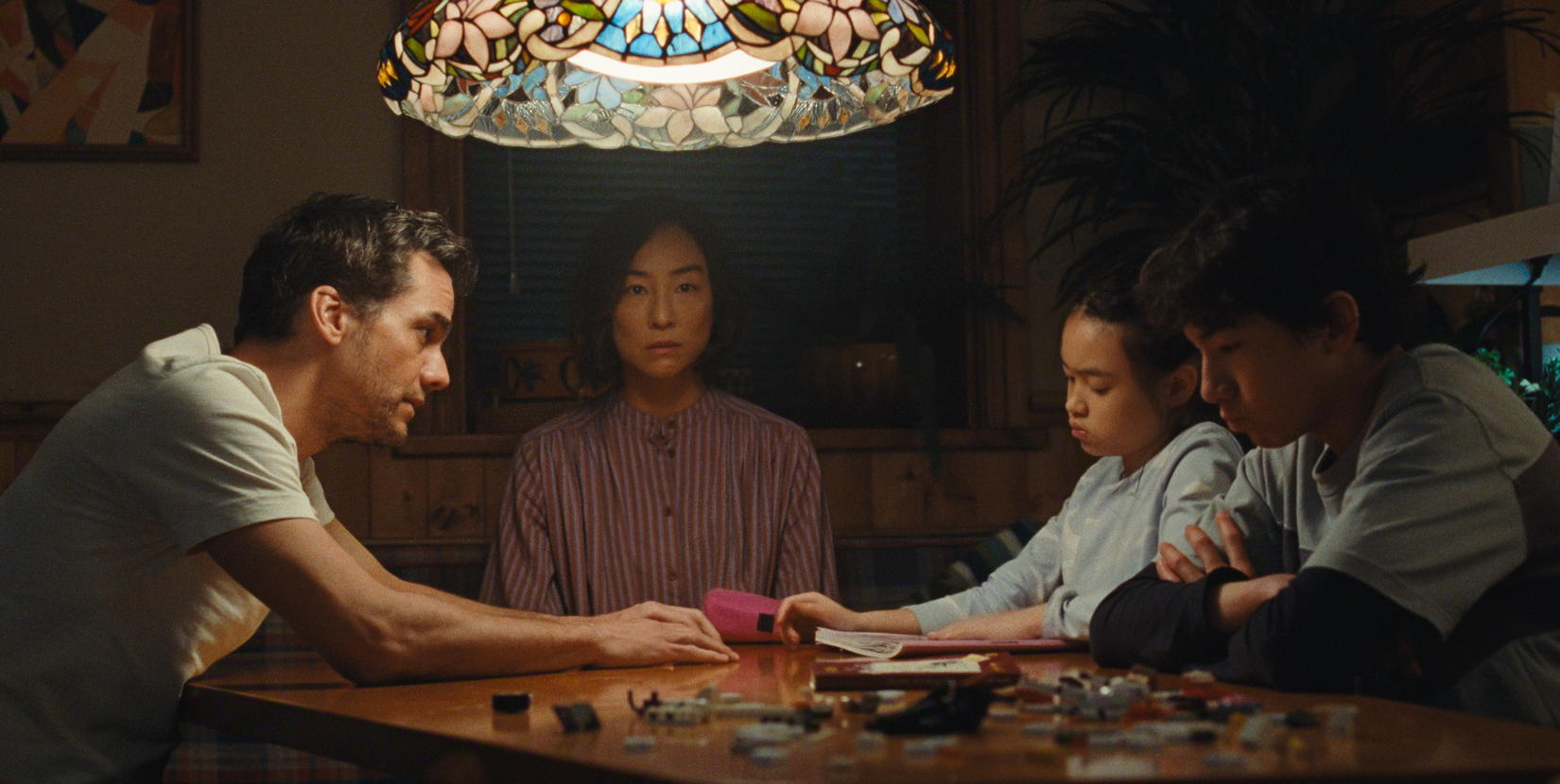 The Last House - Greta Lee stares into space as her family discusses being trapped in a house