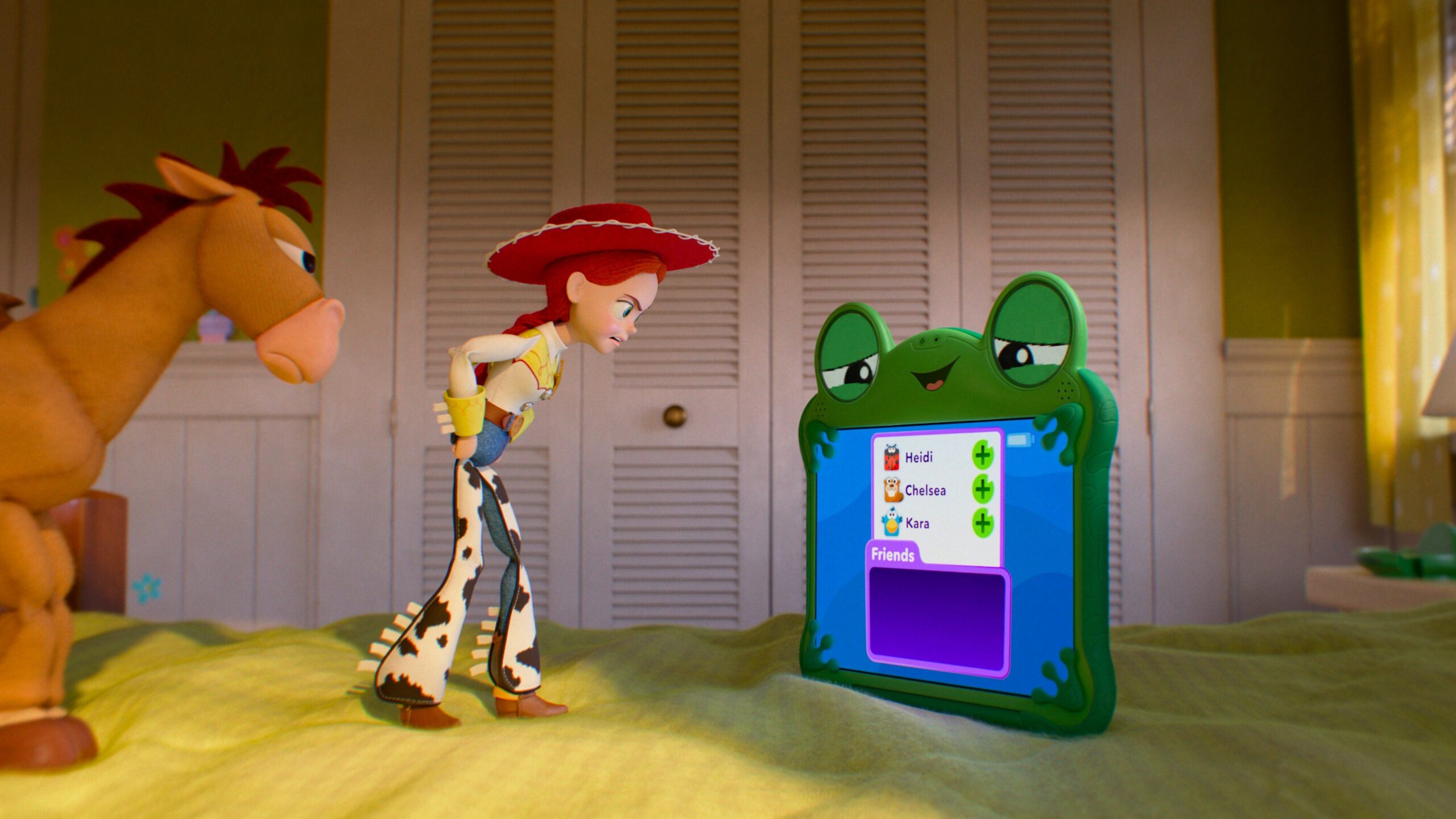 Jessie and Bullseye look upset at the frog tablet Lilypad who looks smug.