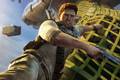 Nathan Drake hangs on to a plane cargo strap for his dear life in a promo shot from Uncharted