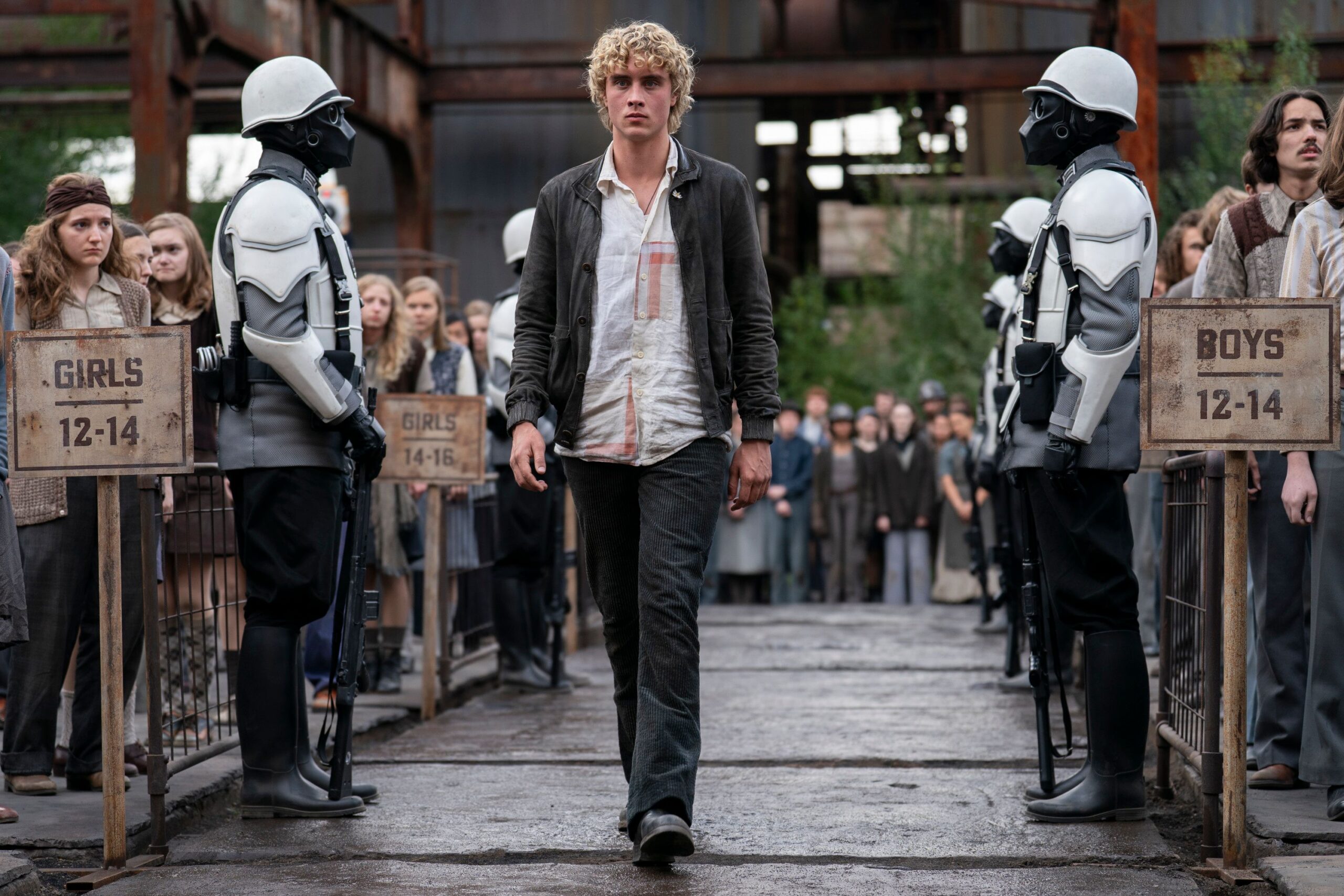 Haymitch walks down District 12 lane when his name is called