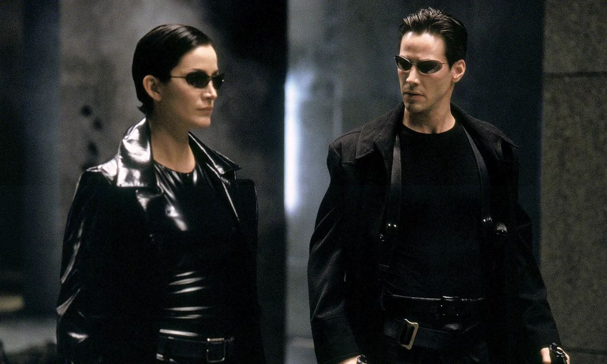Trinity and Neo walk together in The Matrix
