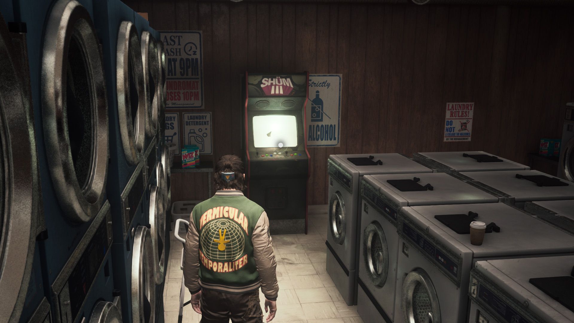 Dylan Faden standing in front of an arcade machine in a laundromat in Control Resonant.