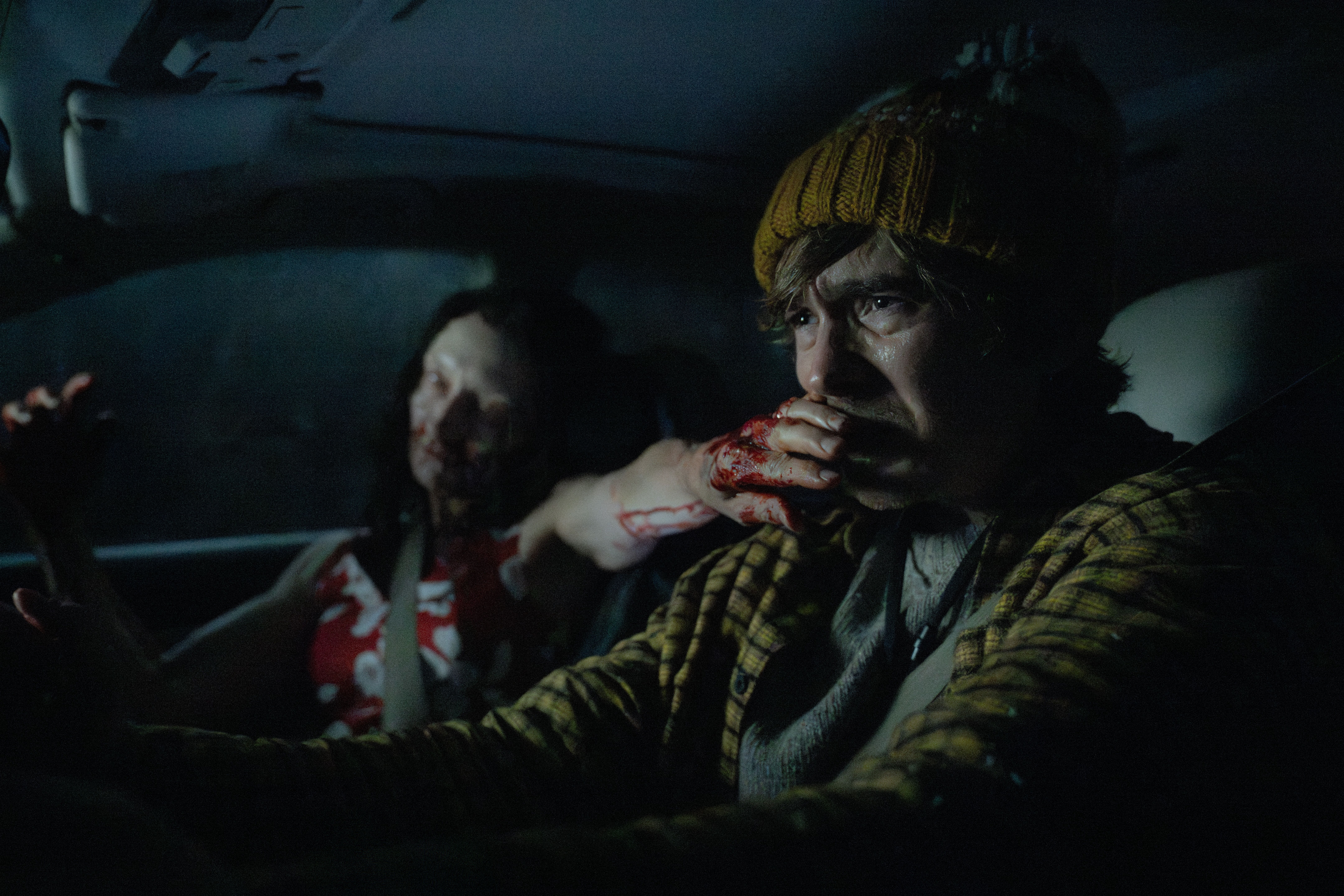 Austin Abrams gets a zombie hand stuck in his face while driving a car in Resident Evil