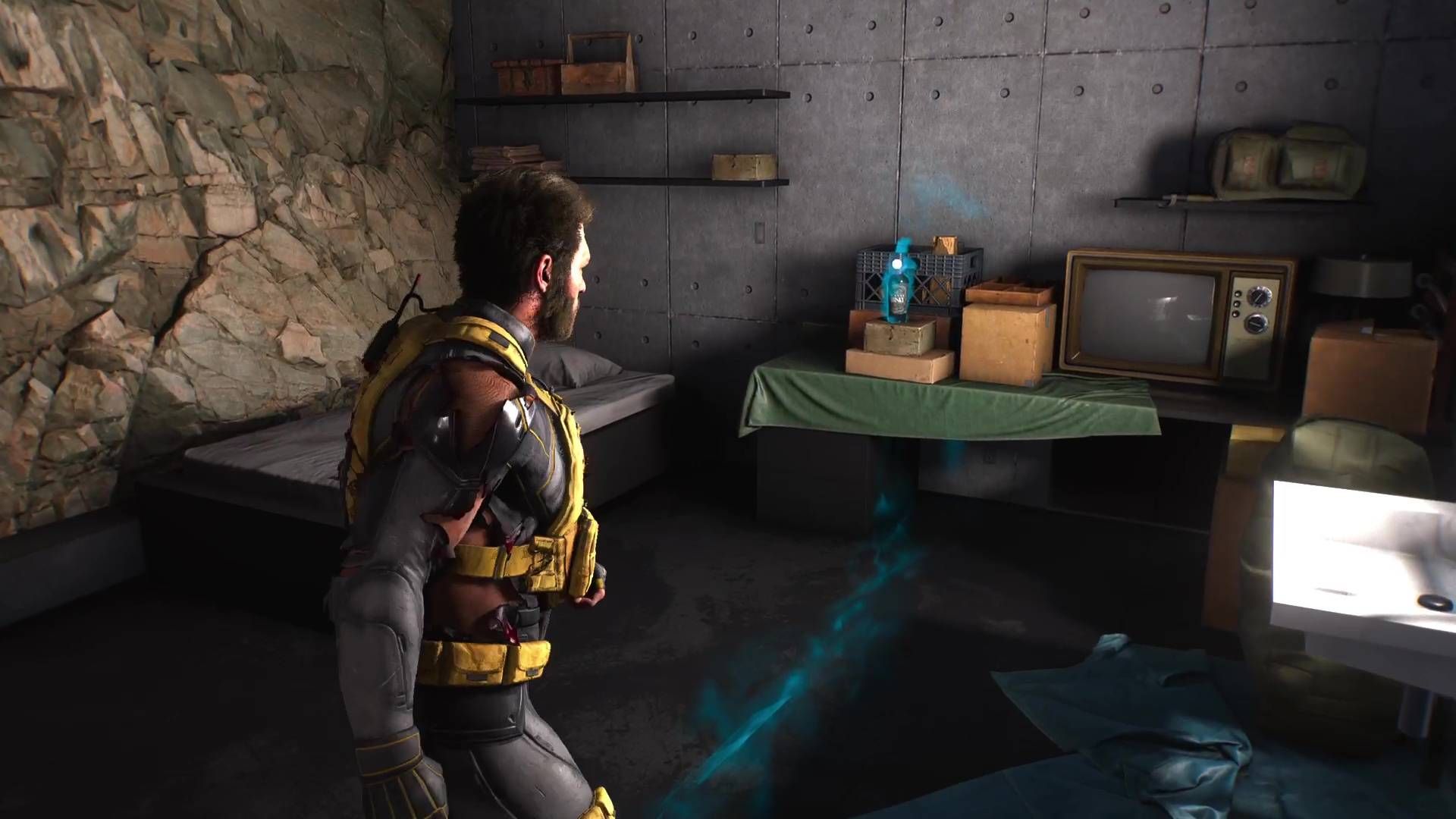 Logan looking at the Uncanny whisky bottle in Marvel's Wolverine.
