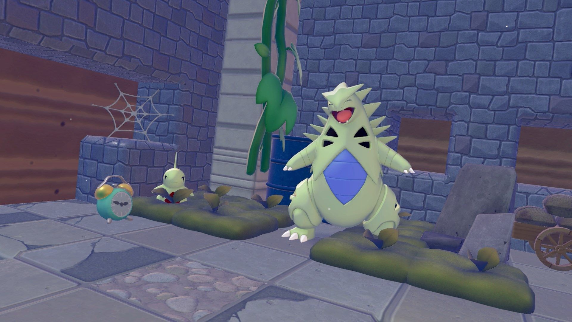 Larvitar and Tyranitar in their moss habitats in Pokopia