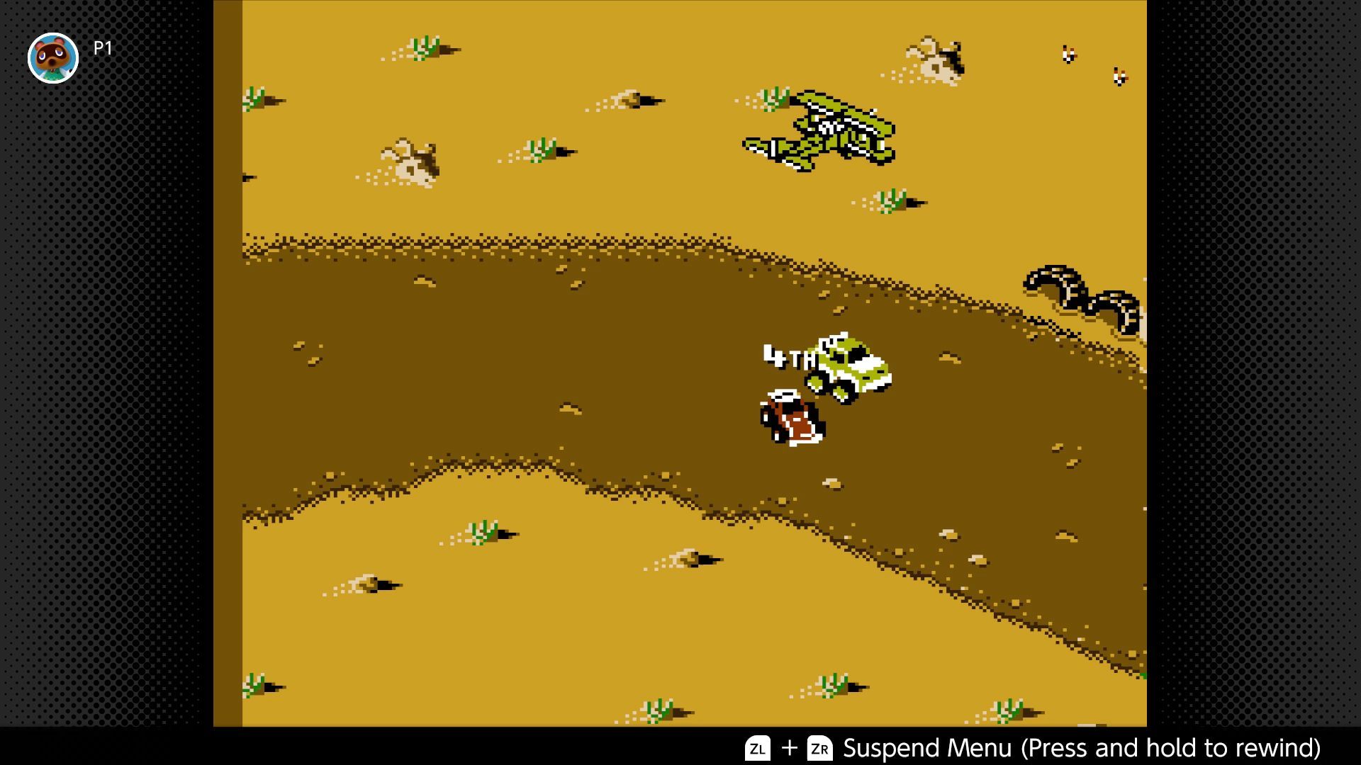 RC Pro-Am 2 screenshot - Red and yellow vehicles round a bend as an airplane flies low overhead in the desert