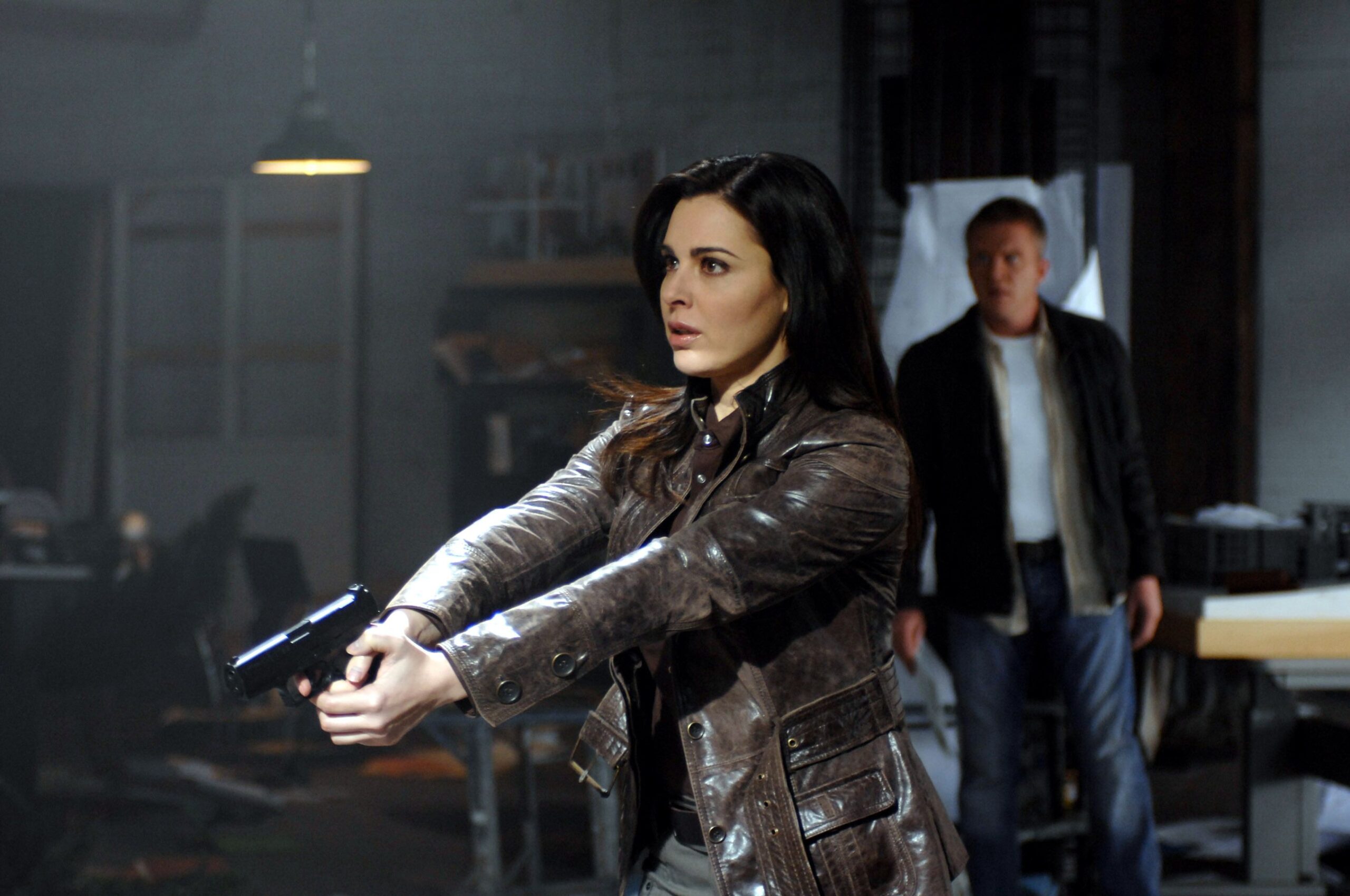 A woman wields a gun in The Dead Zone